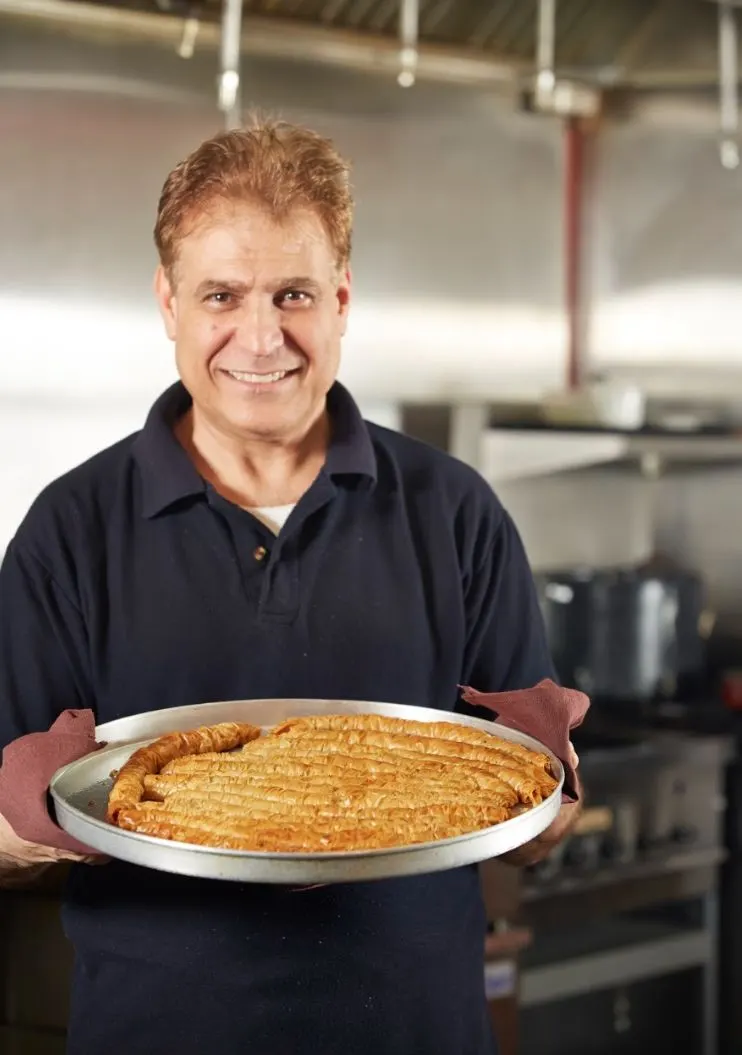 Adnan sharing a freshly prepared dish in the Palmyra kitchen