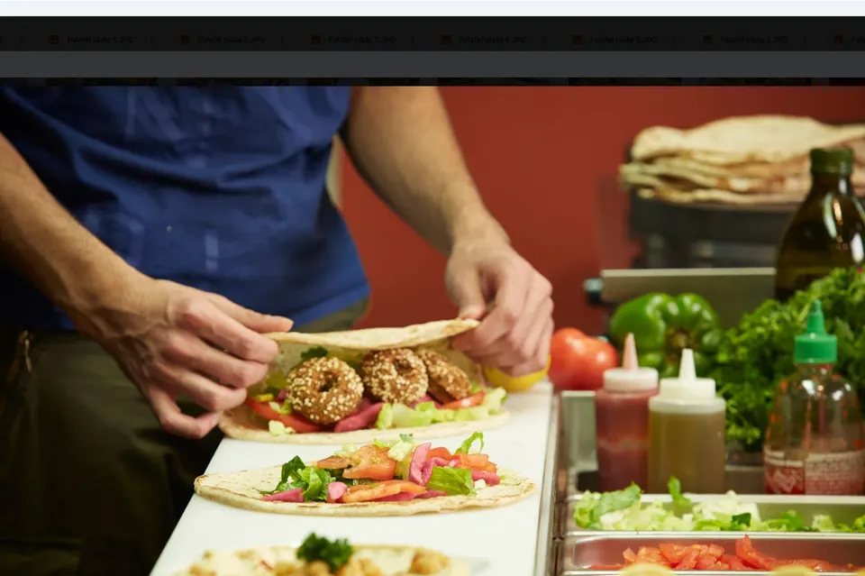 Fresh falafel wraps being made by hand at Palmyra