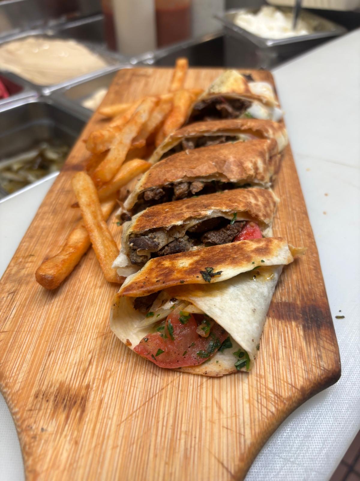 Beef Crispy Arabica shawarma cut into pieces beside fries at Palmyra Mediterranean Grill